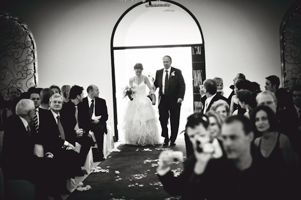black and white photo of bride walking down the aisle - wedding photo by Australia based wedding photographer Natasha Du Preez